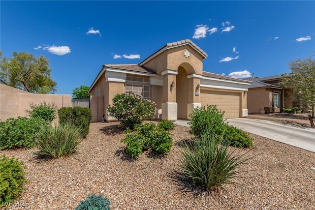 8266 Lincoln Valley St, Las Vegas, NV 89123 - mediterranean / spanish-style home featuring an attached garage, stucco siding, fence, and concrete driveway