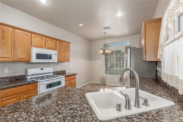 8266 Lincoln Valley St, Las Vegas, NV 89123 - kitchen with white appliances, a sink, recessed lighting, dark stone counters, and decorative light fixtures