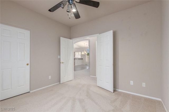 8266 Lincoln Valley St, Las Vegas, NV 89123 - unfurnished bedroom with light carpet, arched walkways, baseboards, and a ceiling fan