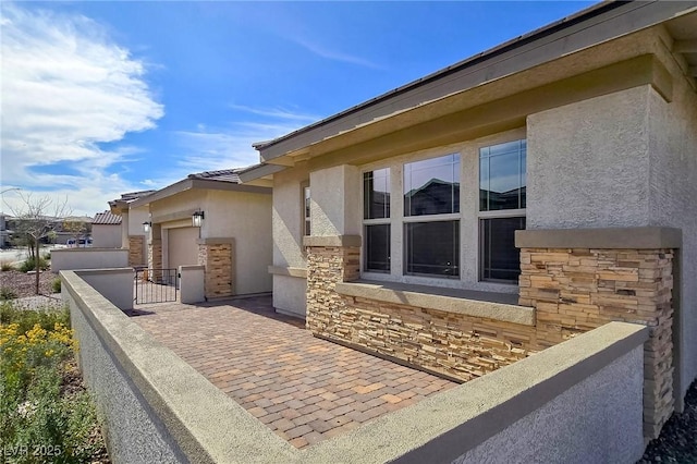 701 Monroe Hill Pl, Henderson, NV 89011 - view of side of home featuring stucco siding and stone siding