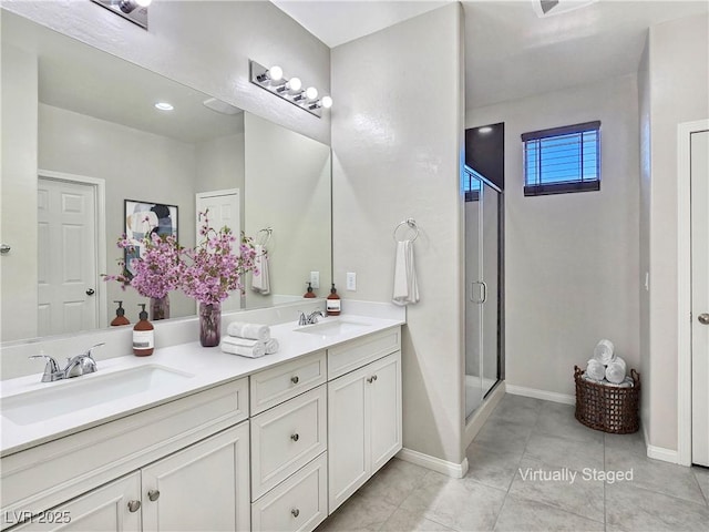 701 Monroe Hill Pl, Henderson, NV 89011 - bathroom with a shower stall, double vanity, tile patterned floors, and baseboards