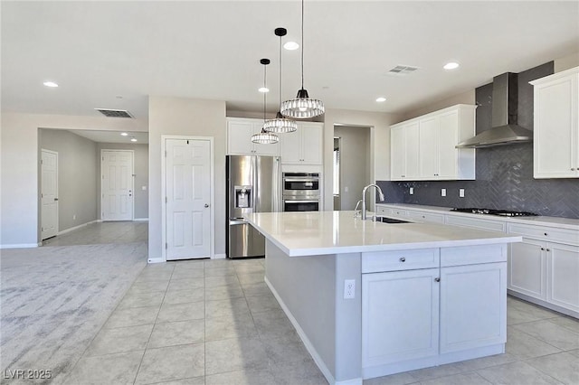701 Monroe Hill Pl, Henderson, NV 89011 - kitchen featuring appliances with stainless steel finishes, wall chimney range hood, a sink, backsplash, and light countertops