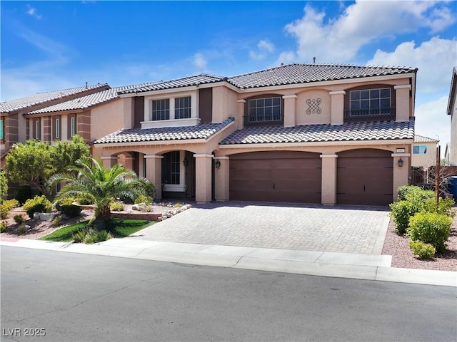 6465 Grande River Ct, Las Vegas, NV 89139 - mediterranean / spanish-style home featuring a garage, stucco siding, a tile roof, and driveway