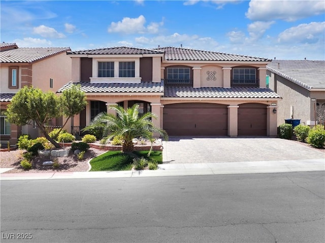 6465 Grande River Ct, Las Vegas, NV 89139 - mediterranean / spanish-style home featuring a tile roof, an attached garage, driveway, and stucco siding