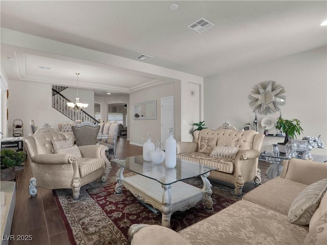 6465 Grande River Ct, Las Vegas, NV 89139 - living area featuring a raised ceiling, a chandelier, arched walkways, wood finished floors, and baseboards