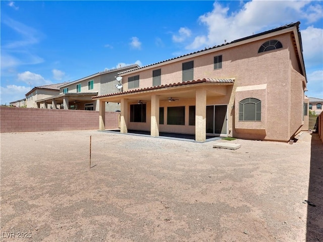 6465 Grande River Ct, Las Vegas, NV 89139 - rear view of property featuring stucco siding, ceiling fan, a fenced backyard, and a patio area