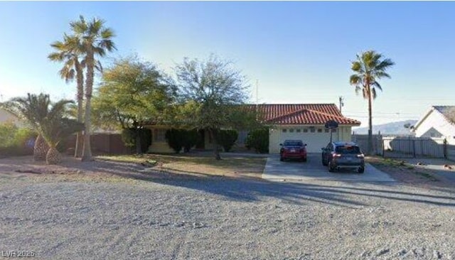 3481 Winery Rd, Pahrump, NV 89048 - view of front of home featuring an attached garage, driveway, and fence