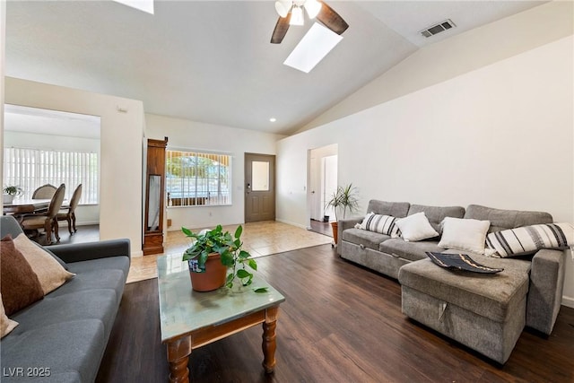 3481 Winery Rd, Pahrump, NV 89048 - living area with a ceiling fan, vaulted ceiling, a skylight, wood finished floors, and baseboards