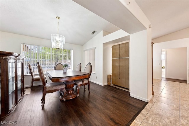 3481 Winery Rd, Pahrump, NV 89048 - dining area with vaulted ceiling, a chandelier, baseboards, and wood finished floors