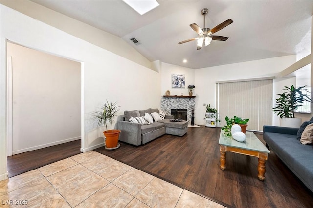 3481 Winery Rd, Pahrump, NV 89048 - tiled living area featuring ceiling fan, a fireplace, lofted ceiling, and baseboards