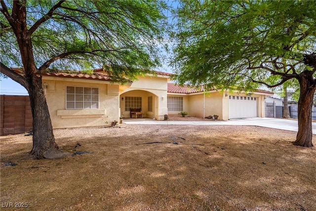 3481 Winery Rd, Pahrump, NV 89048 - mediterranean / spanish-style home featuring stucco siding, a tiled roof, a garage, and concrete driveway