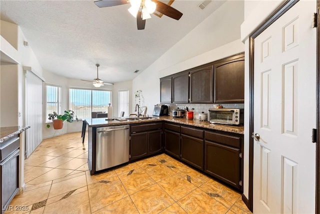 3481 Winery Rd, Pahrump, NV 89048 - kitchen with stainless steel dishwasher, ceiling fan, a sink, dark brown cabinets, and tasteful backsplash