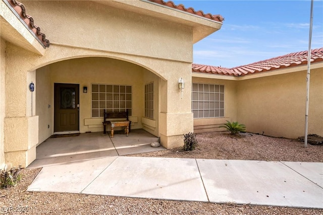 3481 Winery Rd, Pahrump, NV 89048 - view of exterior entry featuring a tiled roof and stucco siding