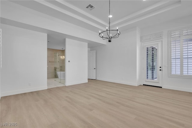 unfurnished dining area featuring a chandelier, a raised ceiling, light wood-style floors, baseboards, and recessed lighting