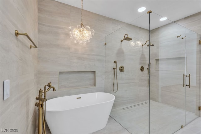 full bath featuring a freestanding bath, a shower stall, tile walls, and recessed lighting
