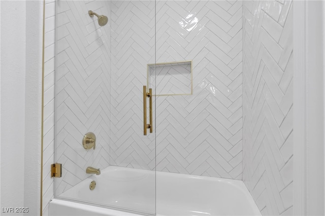 bathroom with shower / bath combination with glass door