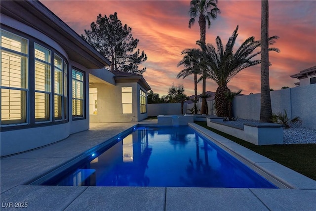 view of pool with a fenced backyard, a patio area, and a pool with connected hot tub