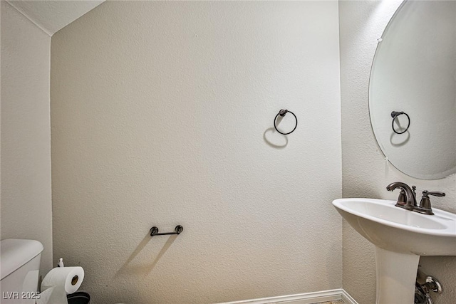 6409 Shawnee Springs Ct, Las Vegas, NV 89139 - half bath featuring toilet, baseboards, and a sink