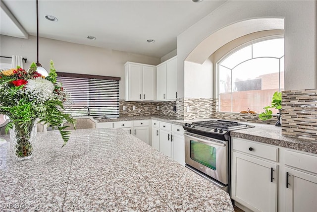 6409 Shawnee Springs Ct, Las Vegas, NV 89139 - kitchen featuring stainless steel gas stove, tile countertops, healthy amount of natural light, and recessed lighting