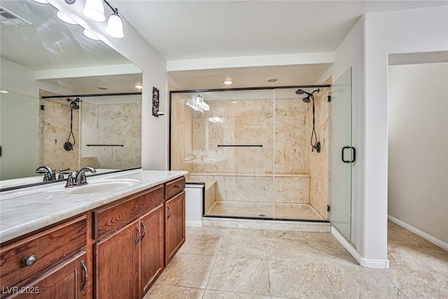 6409 Shawnee Springs Ct, Las Vegas, NV 89139 - bathroom featuring a shower stall, vanity, baseboards, and recessed lighting