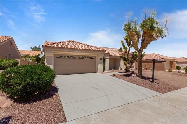 2913 Hawksdale Dr, Las Vegas, NV 89134 - mediterranean / spanish house featuring a tile roof, a garage, stucco siding, and driveway