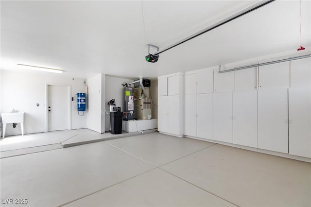 2913 Hawksdale Dr, Las Vegas, NV 89134 - garage featuring a garage door opener, gas water heater, and a sink