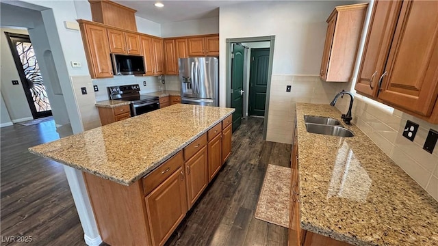 3938 E Chaffe Ave, Pahrump, NV 89061 - kitchen featuring stainless steel appliances, a sink, a center island, dark wood-type flooring, and light stone countertops
