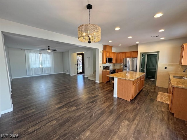 3938 E Chaffe Ave, Pahrump, NV 89061 - kitchen featuring appliances with stainless steel finishes, a chandelier, a sink, a center island, and open floor plan