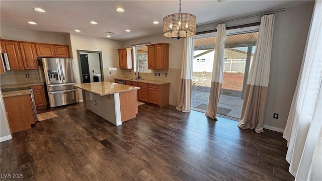 3938 E Chaffe Ave, Pahrump, NV 89061 - kitchen with stainless steel fridge, backsplash, a chandelier, a center island, and recessed lighting