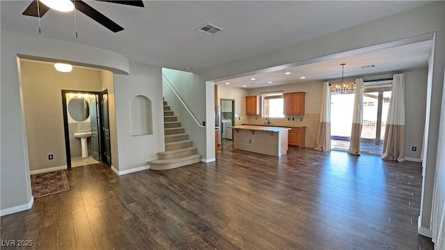 3938 E Chaffe Ave, Pahrump, NV 89061 - unfurnished living room with dark wood-type flooring, a ceiling fan, baseboards, stairs, and recessed lighting