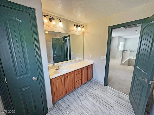 3938 E Chaffe Ave, Pahrump, NV 89061 - bathroom with a textured ceiling, vanity, and baseboards