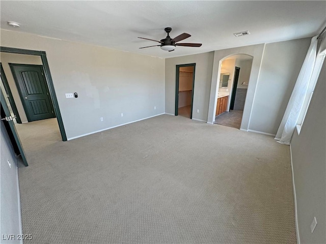 3938 E Chaffe Ave, Pahrump, NV 89061 - unfurnished bedroom featuring arched walkways, baseboards, and light colored carpet