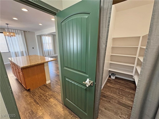 3938 E Chaffe Ave, Pahrump, NV 89061 - kitchen featuring dark wood-style flooring, light stone countertops, recessed lighting, a chandelier, and a center island
