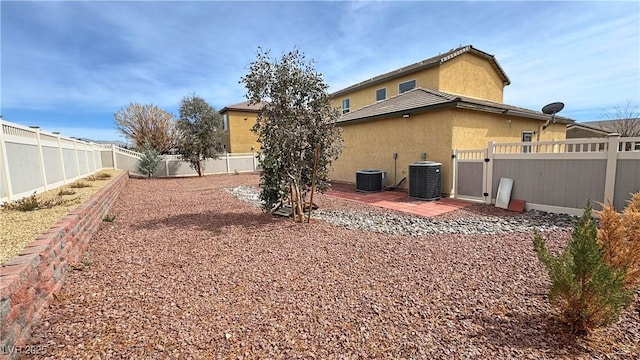3938 E Chaffe Ave, Pahrump, NV 89061 - rear view of house featuring a fenced backyard, central AC unit, a patio area, and stucco siding