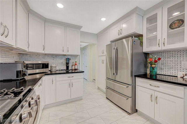 8591 Heather Downs Dr, Las Vegas, NV 89113 - kitchen with appliances with stainless steel finishes, decorative backsplash, glass insert cabinets, recessed lighting, and light marble finish flooring