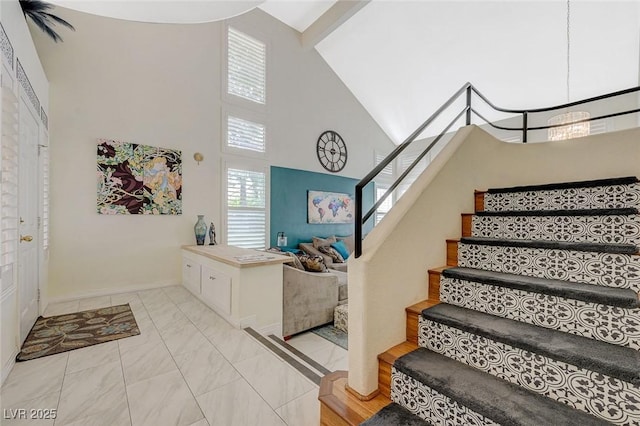 8591 Heather Downs Dr, Las Vegas, NV 89113 - foyer entrance with high vaulted ceiling, stairs, and baseboards