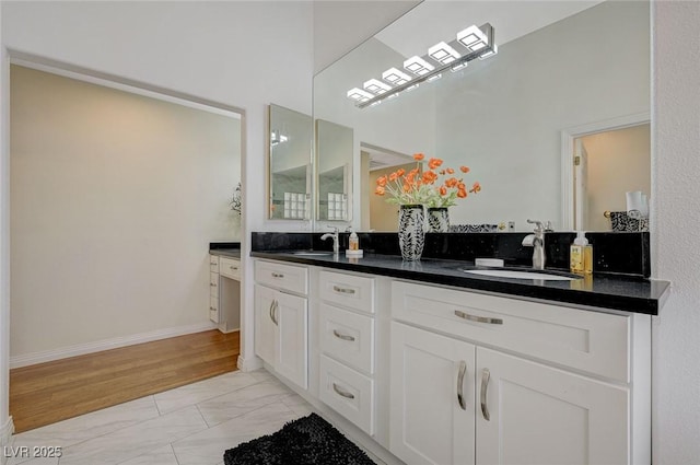 8591 Heather Downs Dr, Las Vegas, NV 89113 - bathroom with marble finish floors, double vanity, a high ceiling, and baseboards