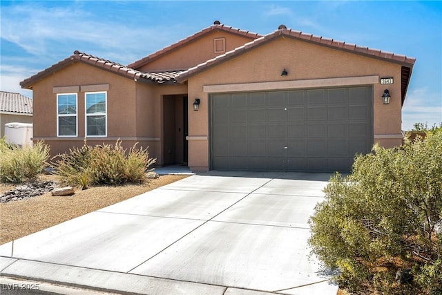 3543 E Malheur Ave, Pahrump, NV 89061 - view of front facade featuring a garage, stucco siding, concrete driveway, and a tile roof
