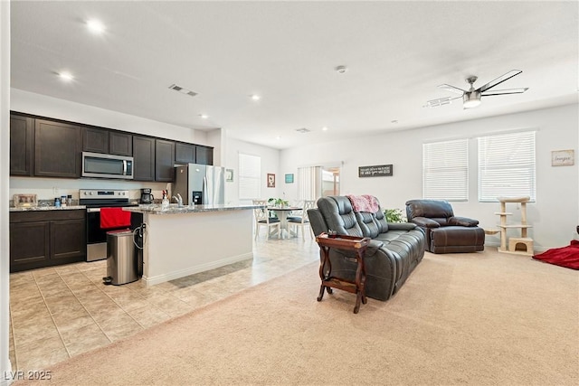 3543 E Malheur Ave, Pahrump, NV 89061 - living area with a ceiling fan, recessed lighting, light tile patterned flooring, and light carpet
