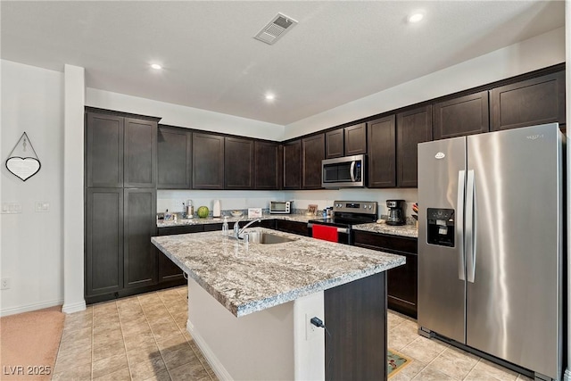 3543 E Malheur Ave, Pahrump, NV 89061 - kitchen featuring stainless steel appliances, a sink, dark brown cabinetry, a center island with sink, and recessed lighting