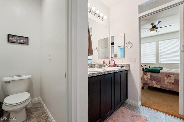 3543 E Malheur Ave, Pahrump, NV 89061 - ensuite bathroom featuring a ceiling fan, toilet, tile patterned flooring, baseboards, and double vanity