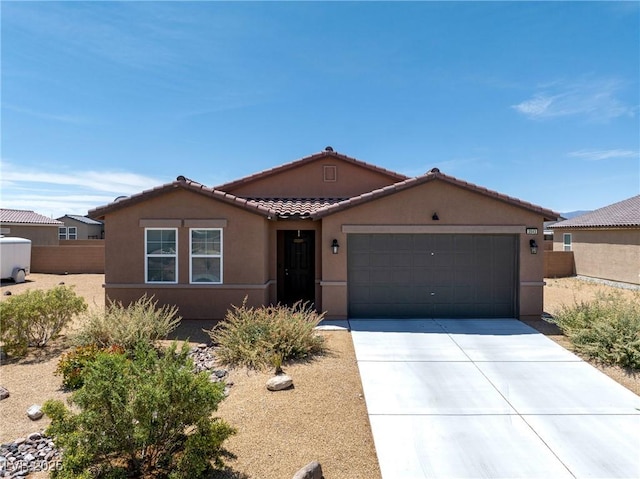 3543 E Malheur Ave, Pahrump, NV 89061 - single story home featuring stucco siding, a tiled roof, an attached garage, and concrete driveway
