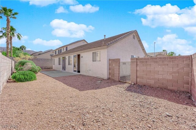 82 Autumn Day St, Henderson, NV 89012 - rear view of property featuring a fenced backyard, stucco siding, a patio area, and a gate