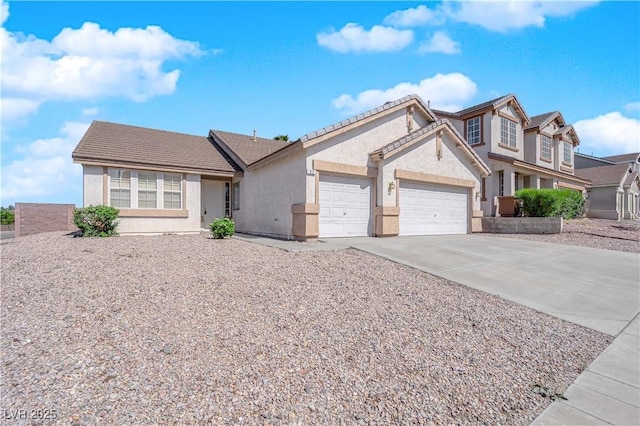 82 Autumn Day St, Henderson, NV 89012 - view of front of property with an attached garage, stucco siding, concrete driveway, and a tile roof