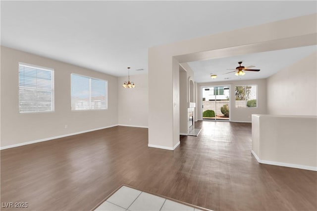 82 Autumn Day St, Henderson, NV 89012 - spare room with a chandelier, dark wood-type flooring, baseboards, and ceiling fan