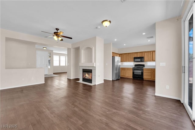 82 Autumn Day St, Henderson, NV 89012 - unfurnished living room with baseboards, ceiling fan, dark wood finished floors, recessed lighting, and a tile fireplace