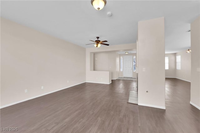 82 Autumn Day St, Henderson, NV 89012 - unfurnished living room featuring baseboards, a ceiling fan, and dark wood-style floors