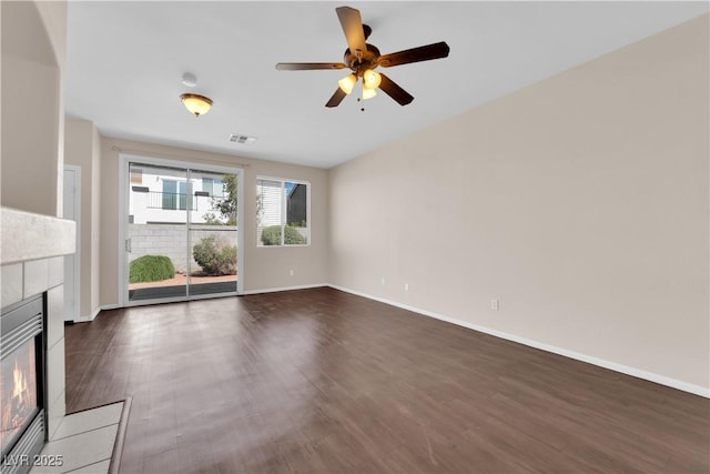 82 Autumn Day St, Henderson, NV 89012 - unfurnished living room featuring a fireplace, ceiling fan, dark wood-type flooring, and baseboards