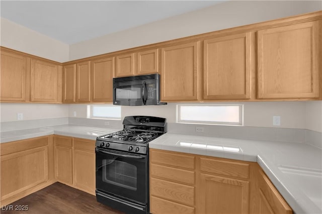 82 Autumn Day St, Henderson, NV 89012 - kitchen with black appliances, light brown cabinets, dark wood-style flooring, and tile counters