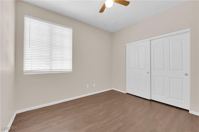 82 Autumn Day St, Henderson, NV 89012 - unfurnished bedroom featuring wood finished floors, baseboards, a closet, and a ceiling fan